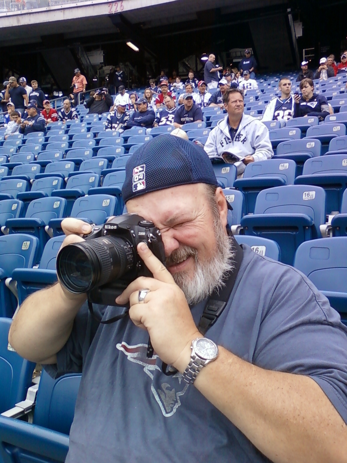 Barrett at Gillette Stadium, Nikon camera raised, capturing a Patriots game