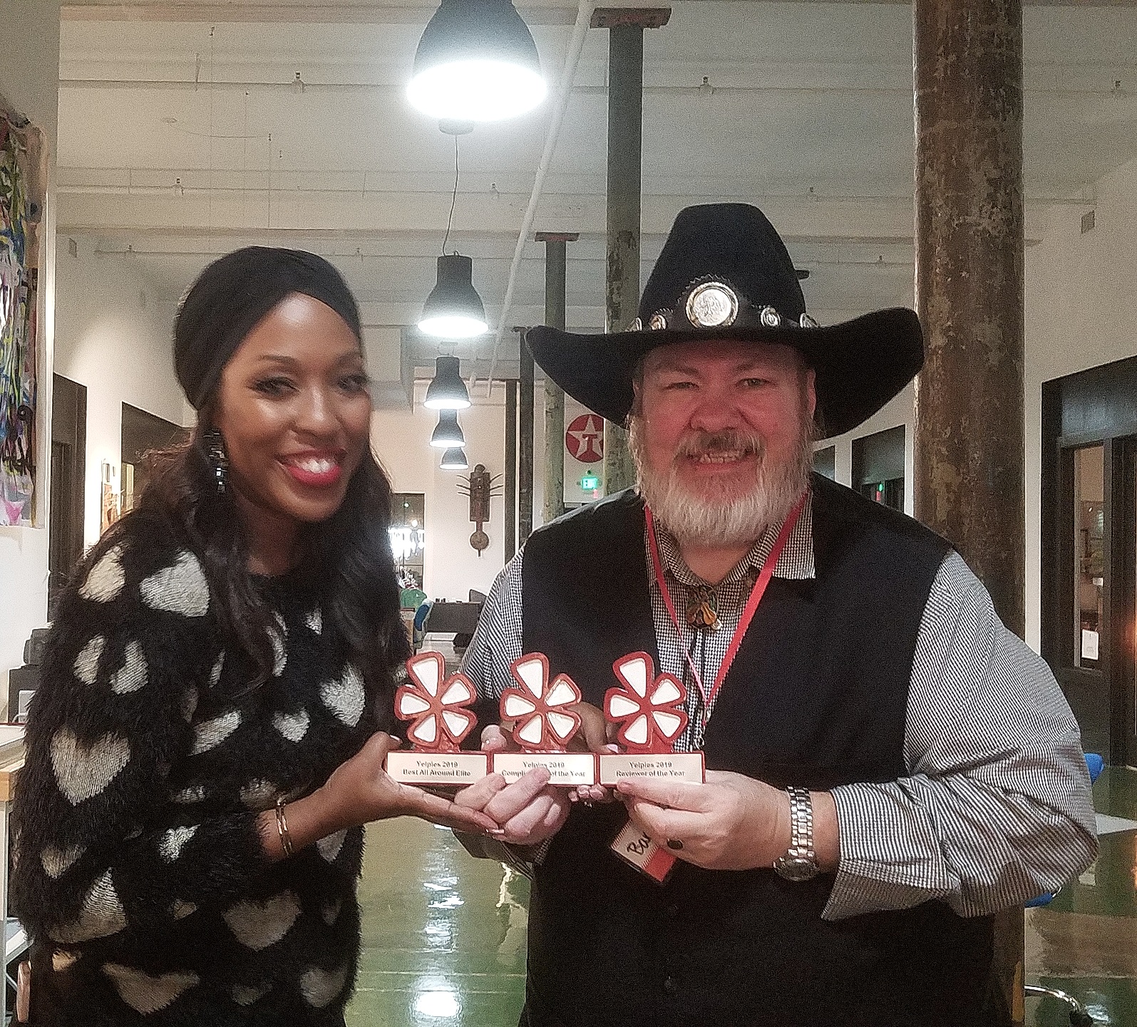 Barrett receiving his Yelp awards — three trophies